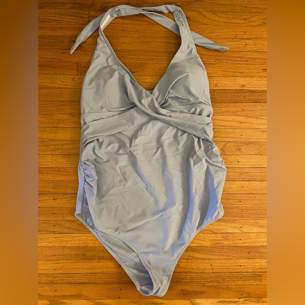 A light blue one piece maternity bathing suit
